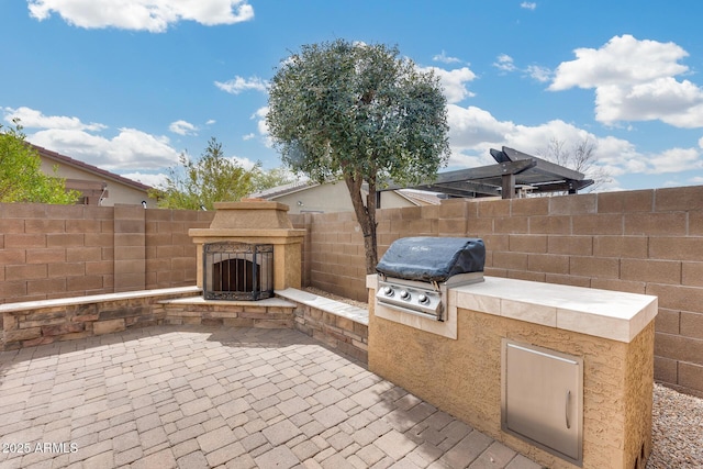 9165 W Mine Trl, Peoria, AZ 85383 - fenced backyard with exterior fireplace and a patio