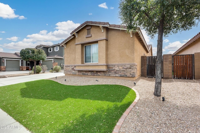 9165 W Mine Trl, Peoria, AZ 85383 - view of front of house featuring stucco siding, a gate, stone siding, and a tile roof