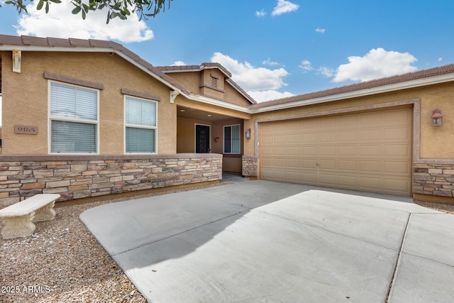 9165 W Mine Trl, Peoria, AZ 85383 - view of front of home featuring stone siding, stucco siding, concrete driveway, and an attached garage