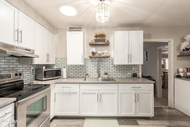 6802 S 47th St, Phoenix, AZ 85042 - kitchen with stainless steel appliances, under cabinet range hood, open shelves, and white cabinetry