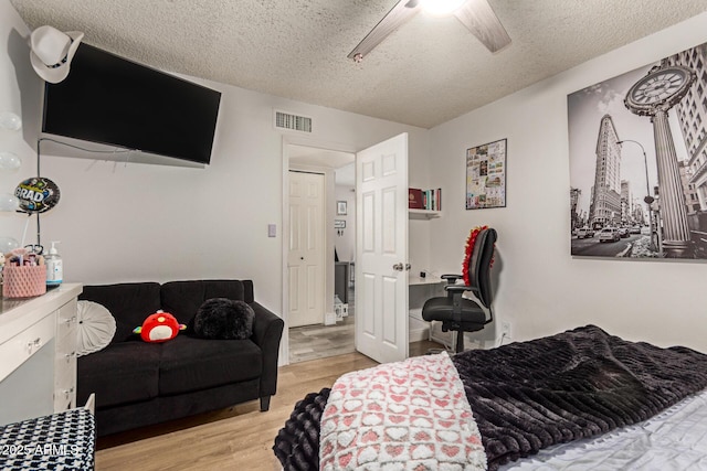 6802 S 47th St, Phoenix, AZ 85042 - bedroom featuring a textured ceiling, wood finished floors, and ceiling fan