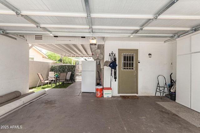 6802 S 47th St, Phoenix, AZ 85042 - garage with freestanding refrigerator and a garage door opener