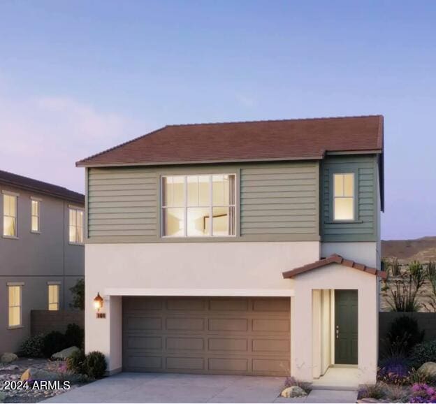 view of front facade with a garage, stucco siding, and driveway