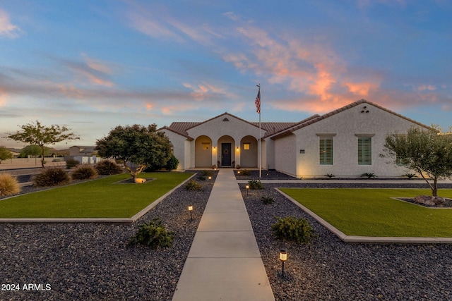 mediterranean / spanish house with a lawn