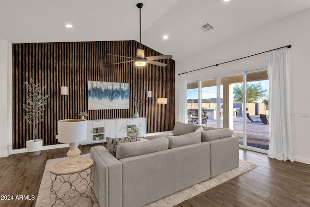 living room with dark wood-type flooring, high vaulted ceiling, and ceiling fan