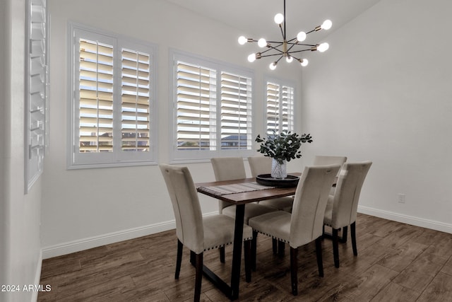 dining space featuring dark hardwood / wood-style flooring and a notable chandelier