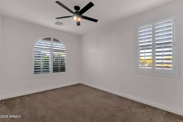 empty room with ceiling fan and carpet floors