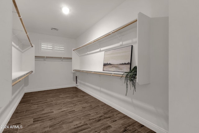 spacious closet with dark hardwood / wood-style floors