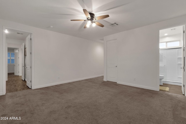 empty room with ceiling fan and dark carpet