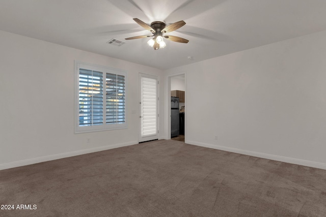 unfurnished room with ceiling fan and carpet flooring