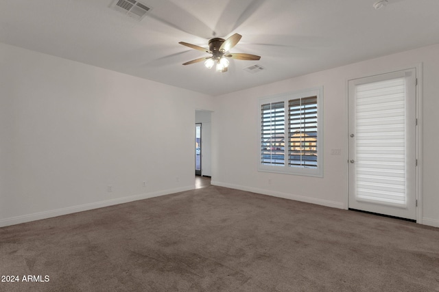 carpeted spare room with ceiling fan