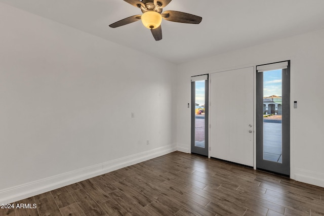 unfurnished room featuring dark wood-type flooring and ceiling fan