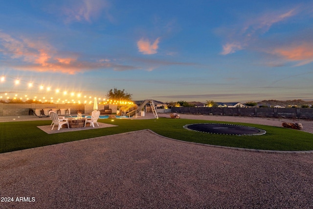 yard at dusk featuring a patio