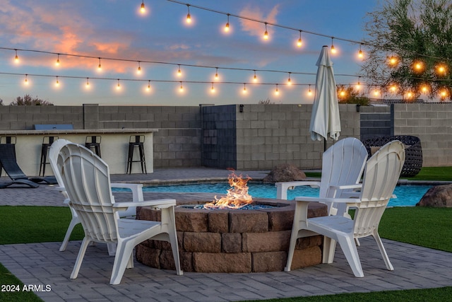 patio terrace at dusk with a fire pit