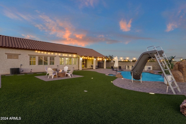 exterior space with central AC, a patio, and a yard