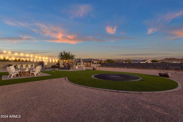 yard at dusk with a fire pit and a patio area