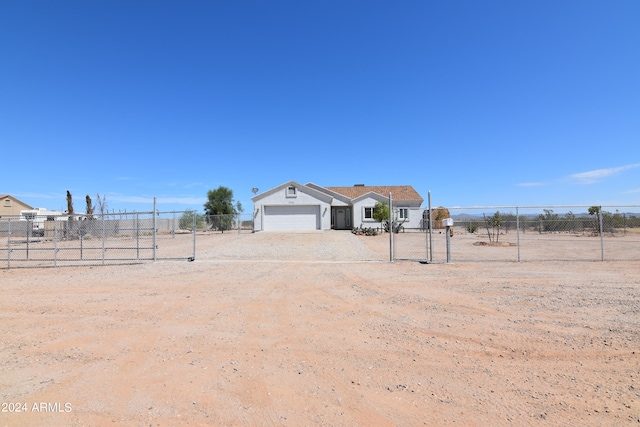 view of yard with a rural view and a garage