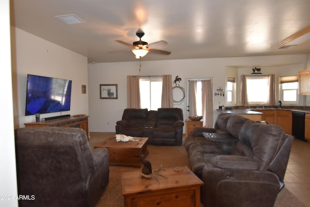 carpeted living room with a healthy amount of sunlight and ceiling fan