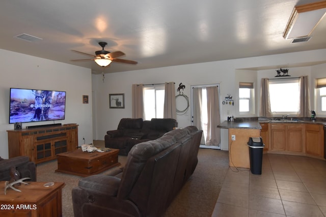 tiled living room featuring sink and ceiling fan