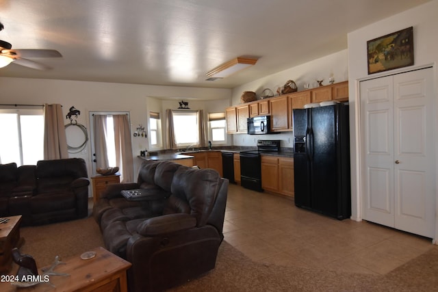 living room with light tile patterned floors and ceiling fan