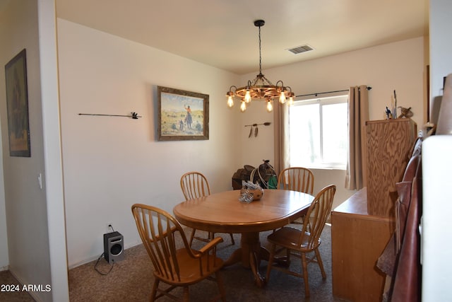 carpeted dining room featuring an inviting chandelier