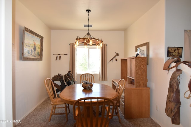 dining room featuring a chandelier and carpet