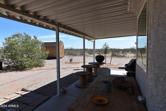 view of patio with a storage shed