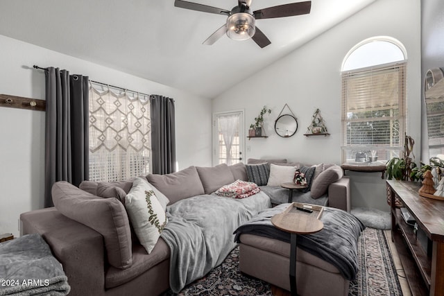 living room featuring ceiling fan, hardwood / wood-style floors, and lofted ceiling