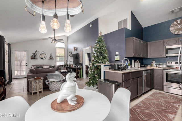 kitchen with ceiling fan, sink, stainless steel appliances, decorative backsplash, and light tile patterned floors