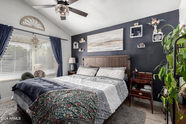 bedroom with ceiling fan, light tile patterned flooring, and lofted ceiling