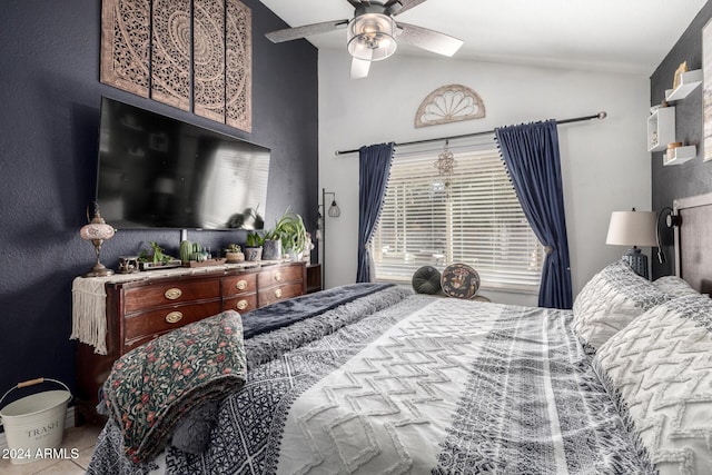 bedroom featuring vaulted ceiling, multiple windows, and ceiling fan