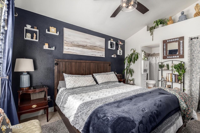 bedroom with tile patterned floors, ensuite bathroom, ceiling fan, and vaulted ceiling