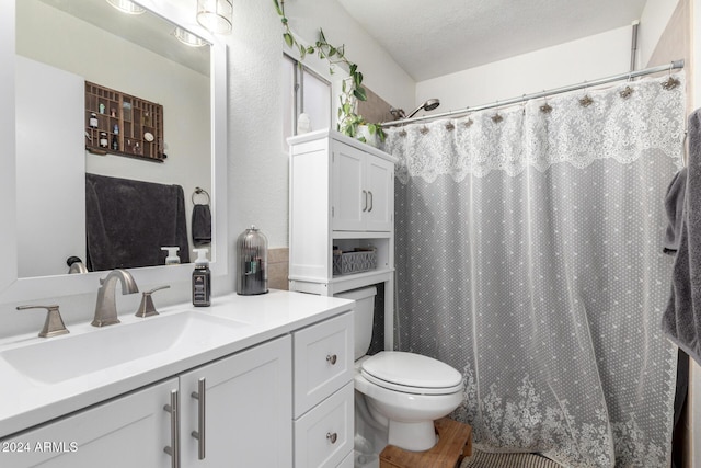 bathroom with vanity, toilet, wood-type flooring, and a textured ceiling