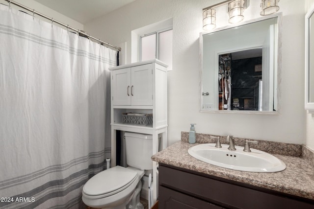 bathroom featuring a shower with curtain, vanity, and toilet