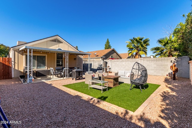 rear view of house with a patio area and outdoor lounge area