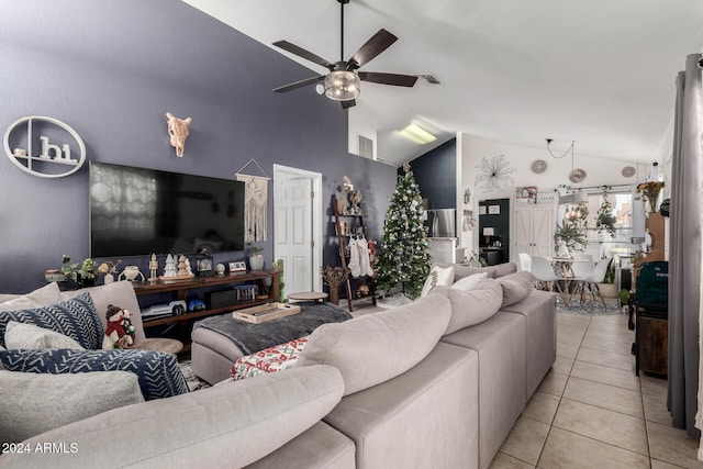 tiled living room with ceiling fan and high vaulted ceiling