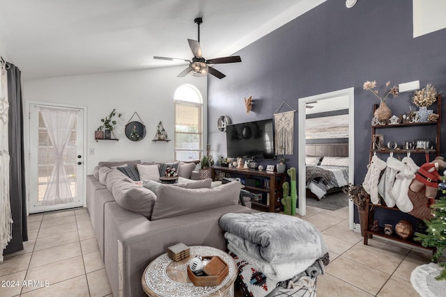 tiled living room with ceiling fan and vaulted ceiling