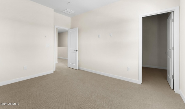 spare room featuring light colored carpet