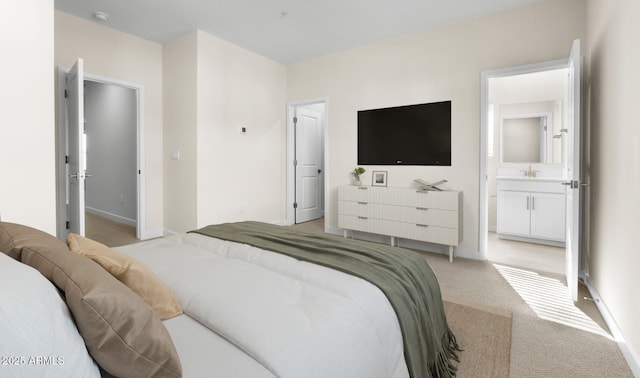 bedroom featuring light colored carpet, connected bathroom, and sink