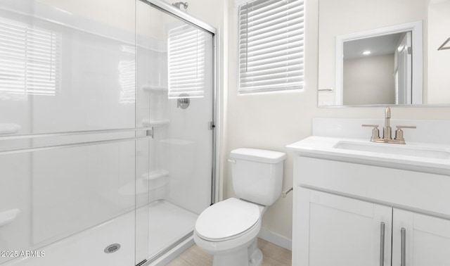 bathroom featuring vanity, toilet, and an enclosed shower