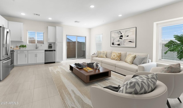 tiled living room featuring sink