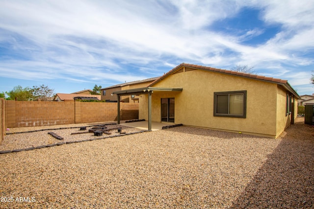 44944 W Miramar Rd, Maricopa, AZ 85139 - back of house with a fenced backyard, stucco siding, and a patio