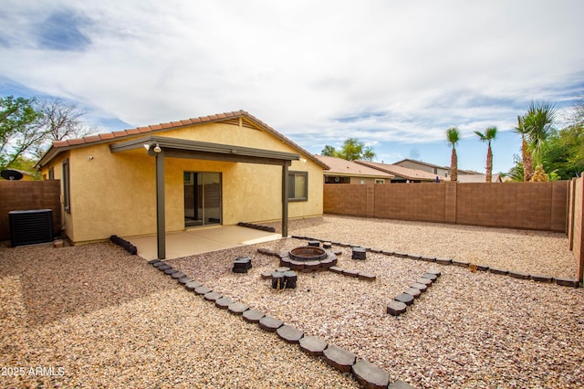 44944 W Miramar Rd, Maricopa, AZ 85139 - rear view of property featuring a fire pit, stucco siding, and a fenced backyard