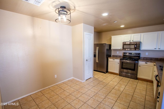 44944 W Miramar Rd, Maricopa, AZ 85139 - kitchen featuring appliances with stainless steel finishes, recessed lighting, white cabinetry, light tile patterned flooring, and dark countertops