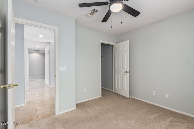 unfurnished bedroom featuring ceiling fan and light carpet