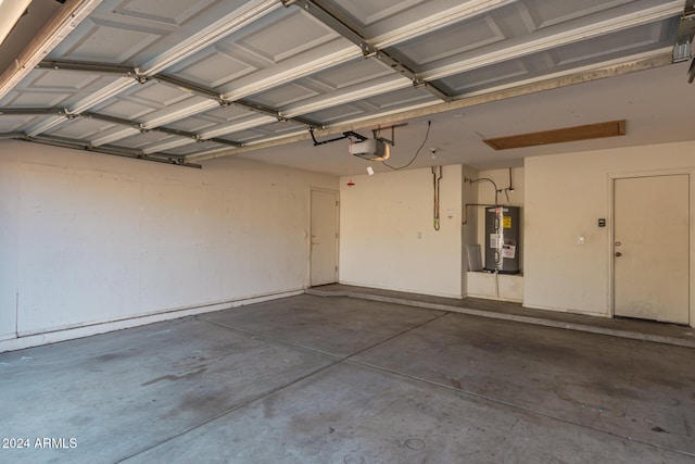 garage featuring a garage door opener and water heater