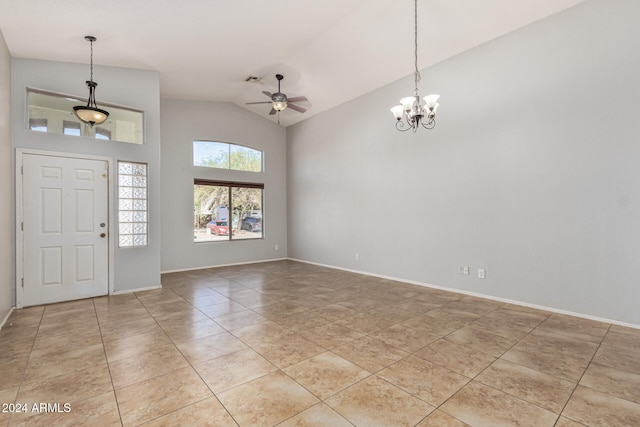 tiled foyer with ceiling fan with notable chandelier and lofted ceiling