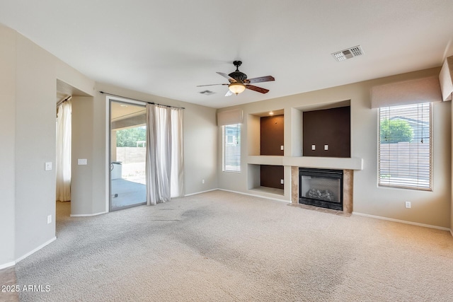 19617 S 190th St, Queen Creek, AZ 85142 - unfurnished living room featuring carpet floors, healthy amount of natural light, a ceiling fan, and a fireplace with flush hearth