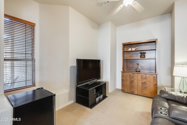 living room featuring light colored carpet and ceiling fan