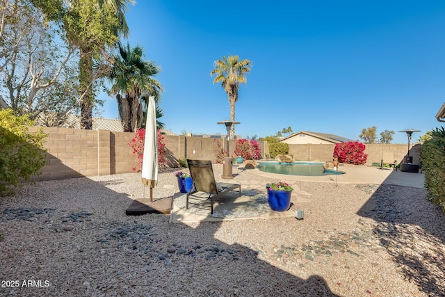 view of yard with a fenced in pool and a patio area